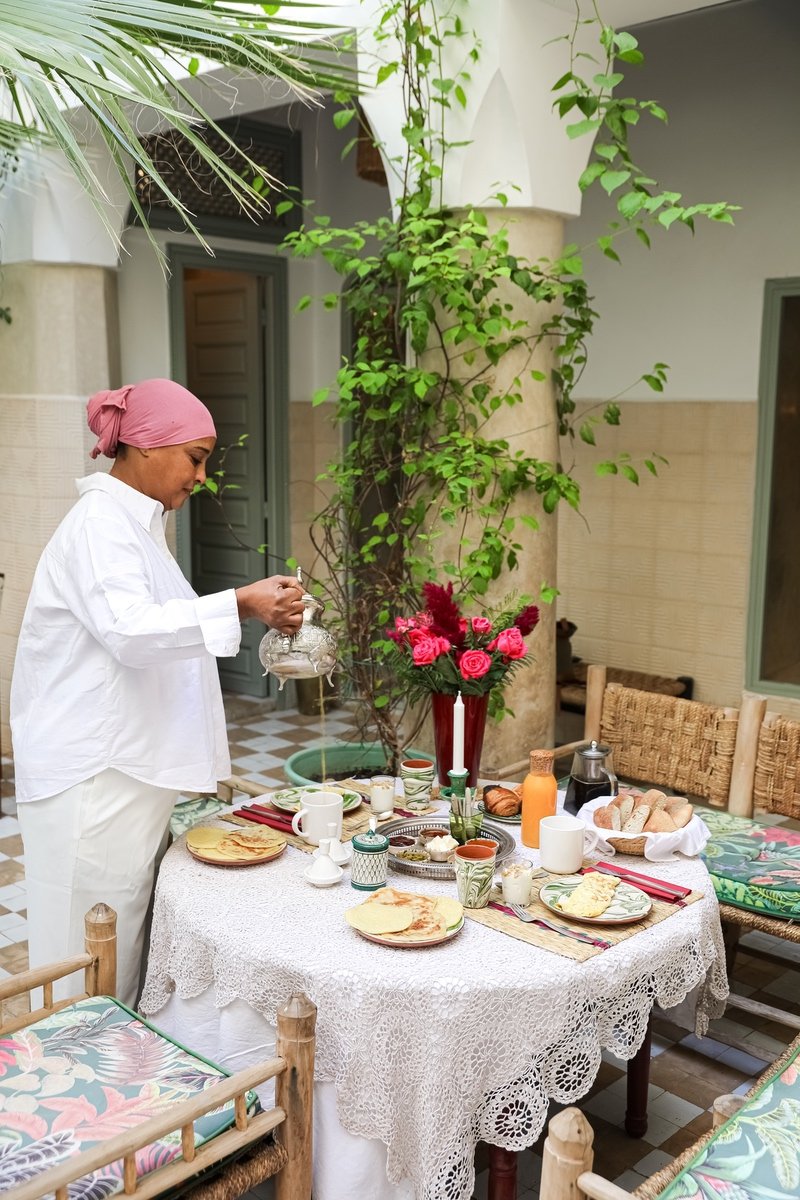 A Riad Amour host preparing breakfast in the patio