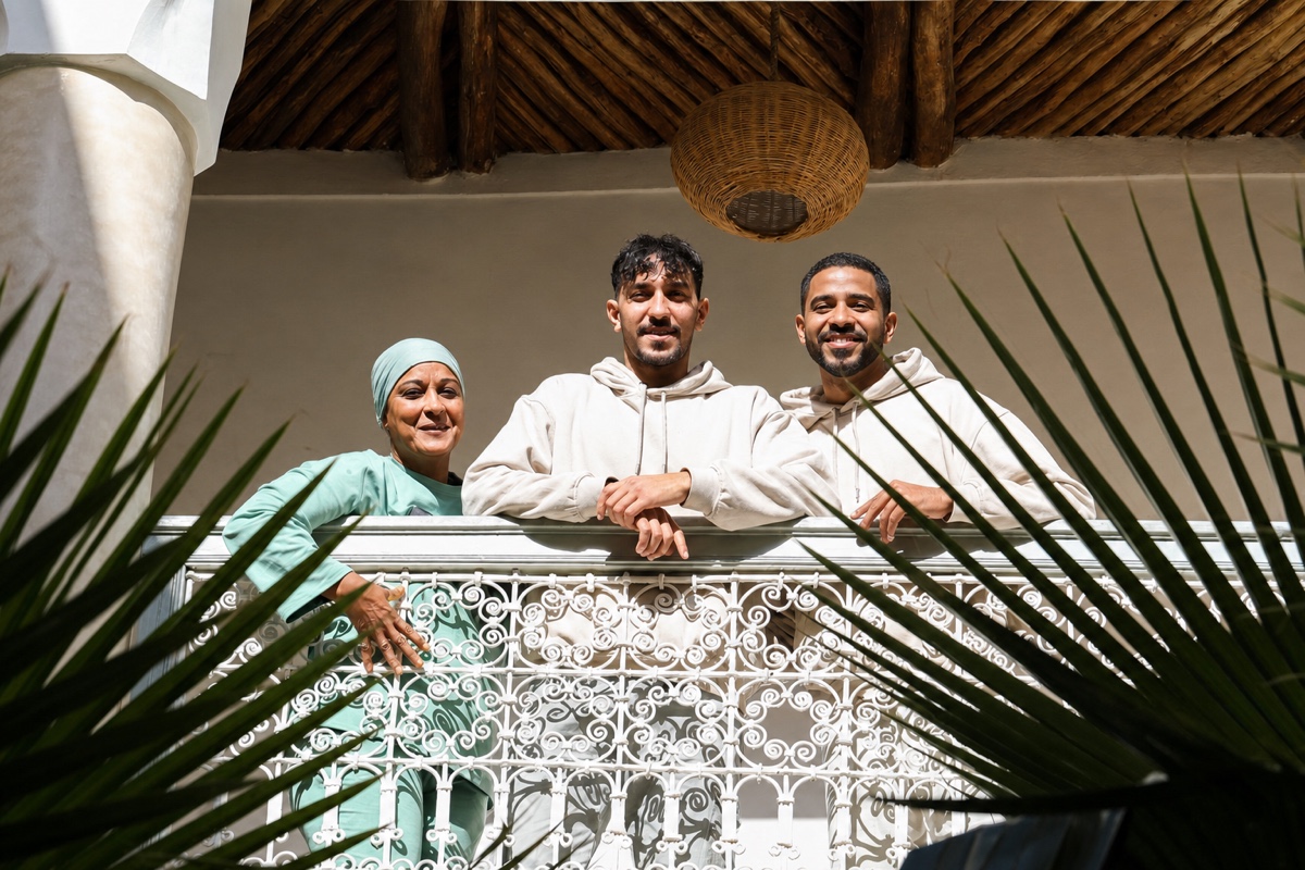 Three members of the Riad Amour team smiling on the terrace