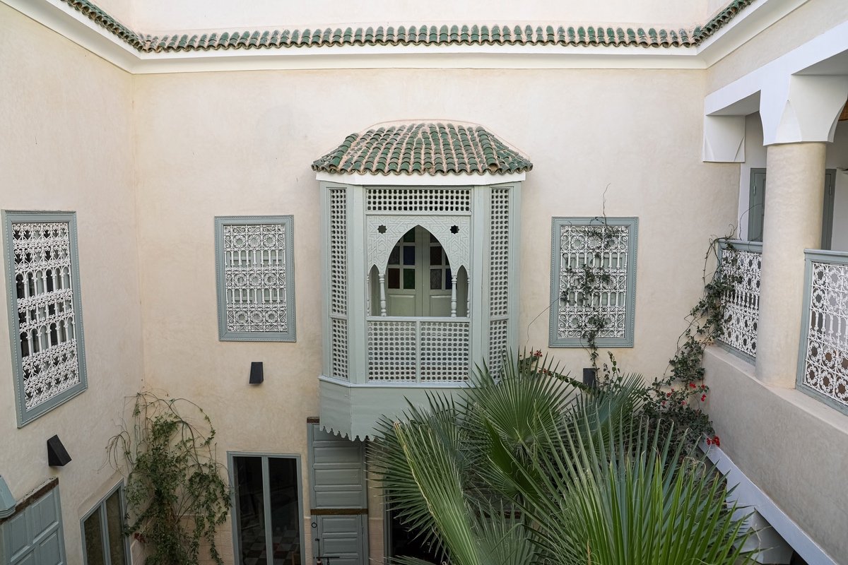 The plant-filled patio and upper galleries at Riad Amour